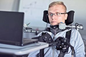Disabled Man Using Computer with Assistive Devices